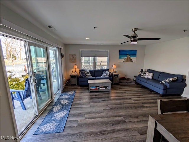 living area with ceiling fan, wood finished floors, visible vents, and recessed lighting