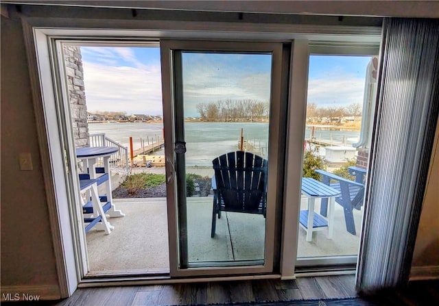 doorway featuring a water view and wood finished floors