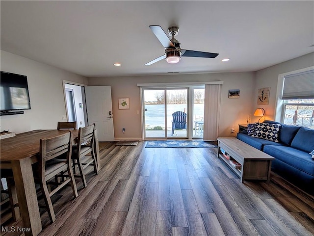 living room with dark wood finished floors, plenty of natural light, baseboards, and recessed lighting