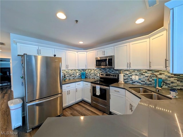 kitchen featuring white cabinetry, stainless steel appliances, and a sink