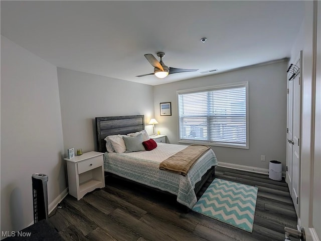 bedroom featuring dark wood-style floors, visible vents, and baseboards