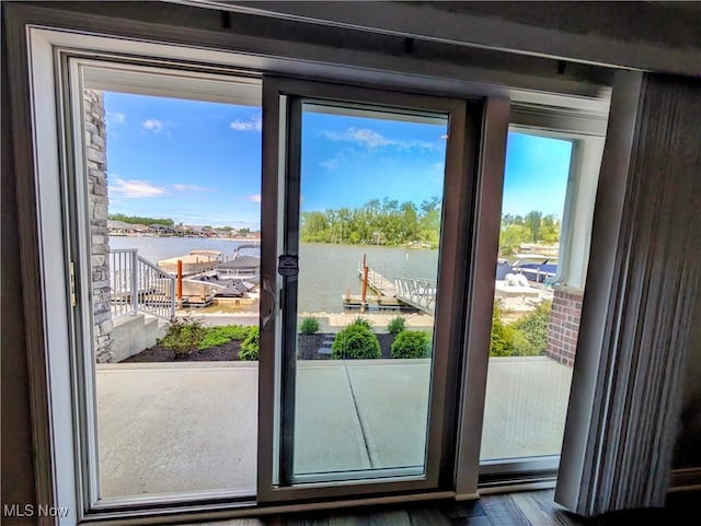 2568 S Waterside Ct Unit 211, Lakeside-Marblehead, OH 43440 - entryway featuring a water view, healthy amount of natural light, and wood finished floors