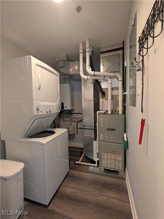 2568 S Waterside Ct Unit 211, Lakeside-Marblehead, OH 43440 - washroom featuring estacked washer and dryer, tankless water heater, wood finished floors, and baseboards