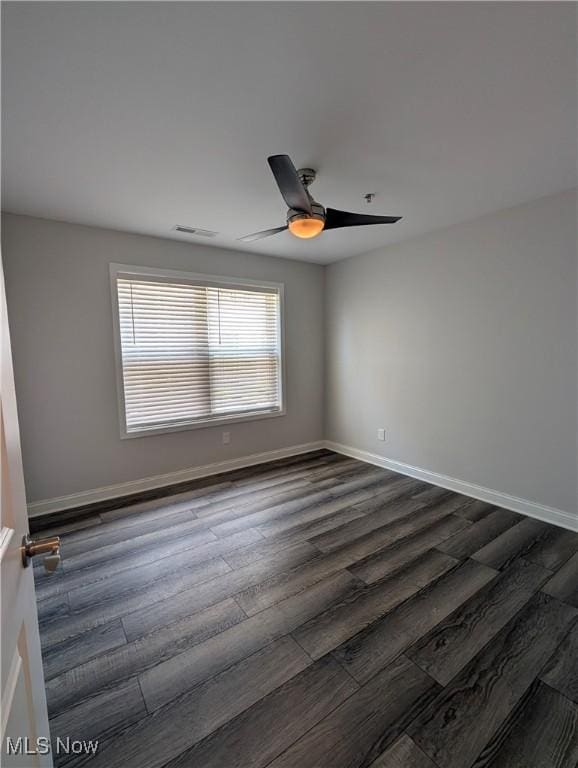 2568 S Waterside Ct Unit 211, Lakeside-Marblehead, OH 43440 - spare room with dark wood finished floors, baseboards, and ceiling fan