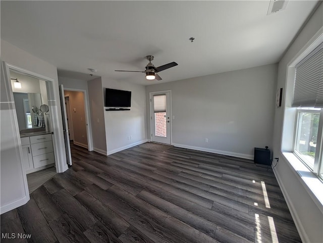 2568 S Waterside Ct Unit 211, Lakeside-Marblehead, OH 43440 - spare room with dark wood-style flooring, ceiling fan, healthy amount of natural light, and baseboards