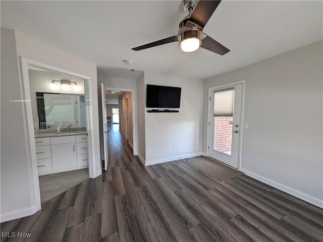 2568 S Waterside Ct Unit 211, Lakeside-Marblehead, OH 43440 - unfurnished bedroom with dark wood-type flooring, a sink, baseboards, ensuite bath, and a ceiling fan