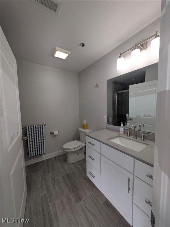 2568 S Waterside Ct Unit 211, Lakeside-Marblehead, OH 43440 - full bath with vanity, a stall shower, toilet, and baseboards