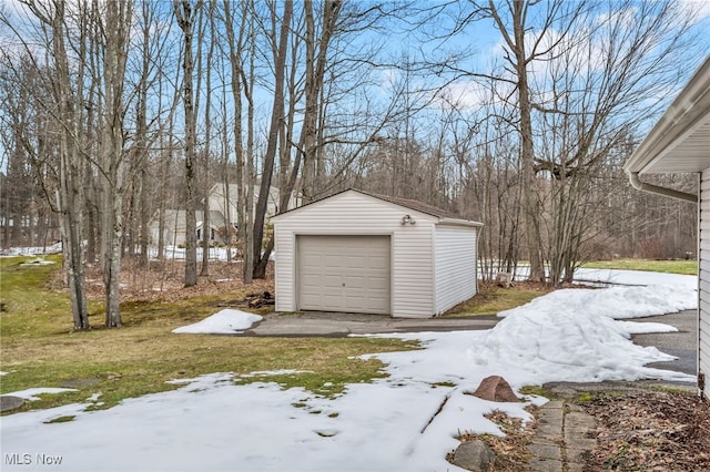 snow covered garage with a garage