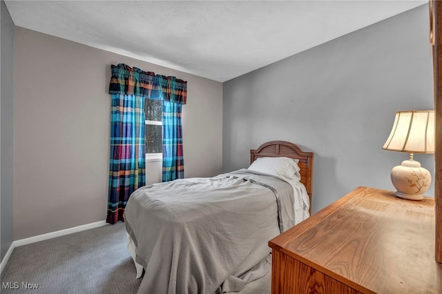 carpeted bedroom featuring baseboards