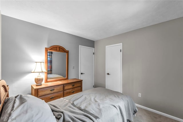 bedroom with carpet floors and baseboards