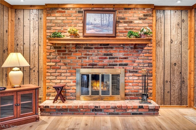 room details featuring a brick fireplace and wood finished floors