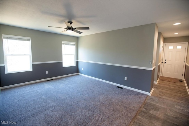 carpeted empty room featuring a ceiling fan, recessed lighting, visible vents, and baseboards