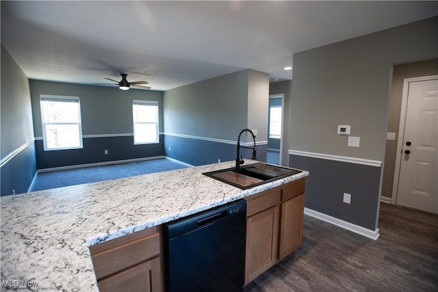 kitchen with dark wood-style flooring, baseboards, dishwasher, and a sink