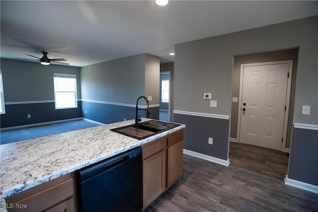 kitchen featuring ceiling fan, dark wood-style flooring, a sink, baseboards, and black dishwasher