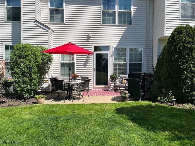 back of house featuring a yard and a patio