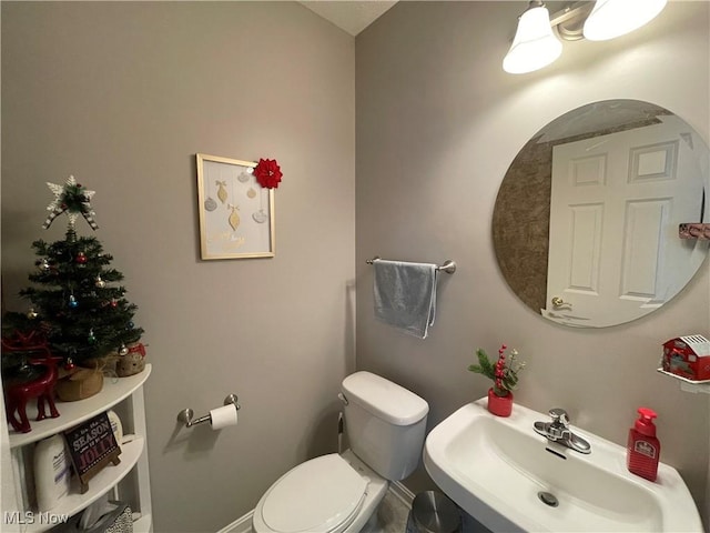 bathroom featuring toilet and a sink