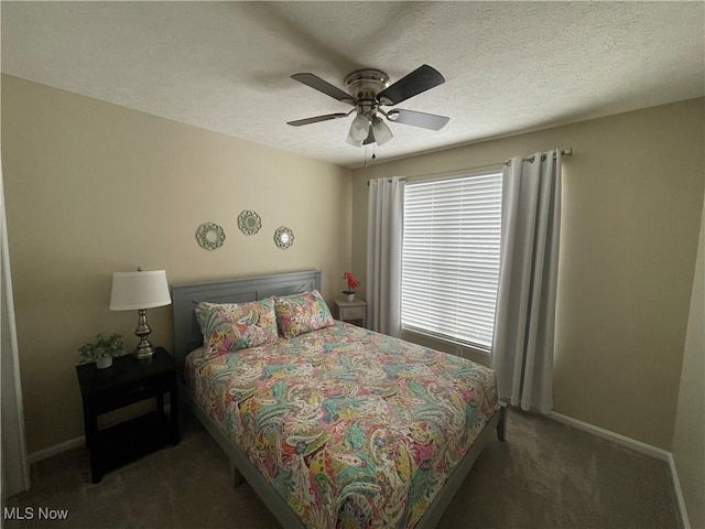 bedroom featuring a textured ceiling, carpet flooring, a ceiling fan, and baseboards