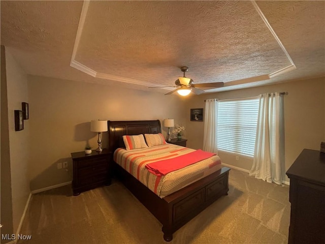 bedroom with carpet floors, a raised ceiling, ceiling fan, a textured ceiling, and baseboards