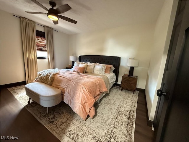 bedroom featuring ceiling fan, baseboards, and wood finished floors