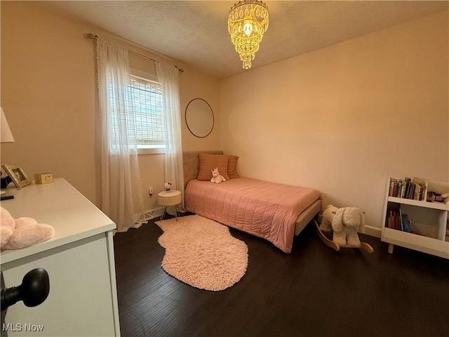 bedroom with dark wood-style flooring