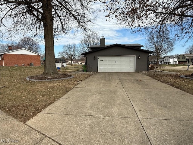 view of property exterior with a garage, concrete driveway, a chimney, and stucco siding