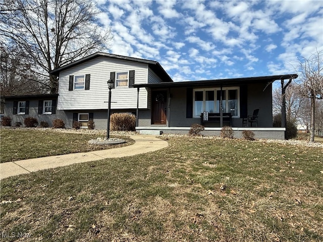 split level home featuring a porch and a front yard