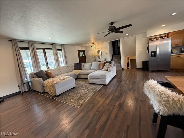 living area featuring dark wood-type flooring, recessed lighting, baseboards, and stairs