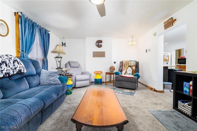 living room with ceiling fan, carpet, and baseboards