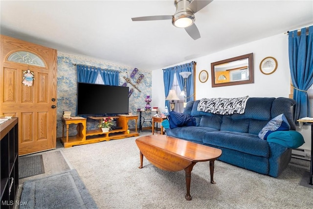 living room with a ceiling fan, a baseboard radiator, a healthy amount of sunlight, and wallpapered walls