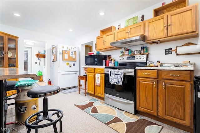 kitchen with light countertops, freestanding refrigerator, black microwave, under cabinet range hood, and stainless steel electric range