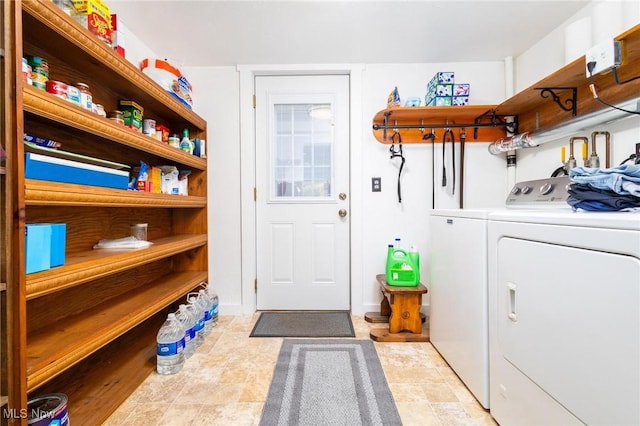 washroom featuring laundry area and washing machine and dryer