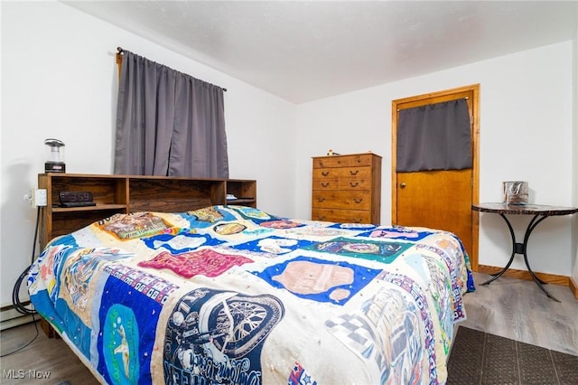 bedroom featuring wood finished floors