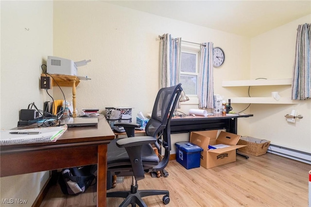 home office featuring a baseboard radiator and wood finished floors