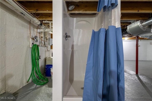 bathroom with concrete floors and a shower with shower curtain