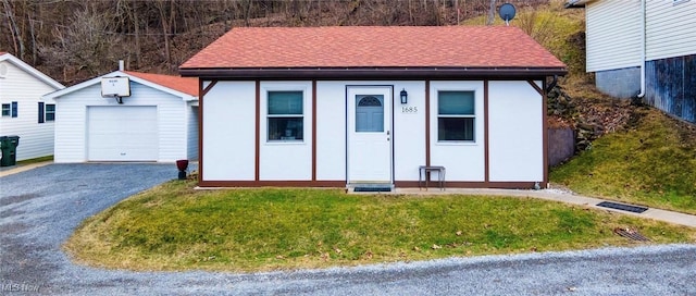 exterior space with driveway and an outdoor structure