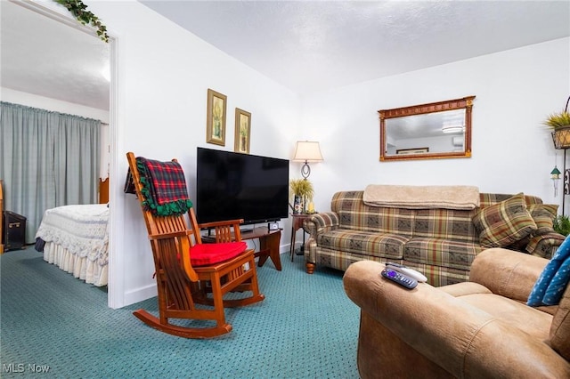 living area featuring carpet floors and baseboards