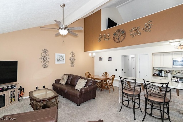 living room with light carpet, high vaulted ceiling, a ceiling fan, and baseboards