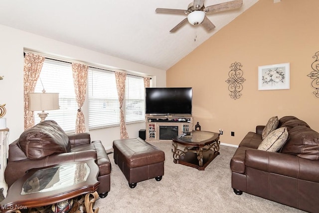 carpeted living area featuring a ceiling fan, lofted ceiling, and baseboards