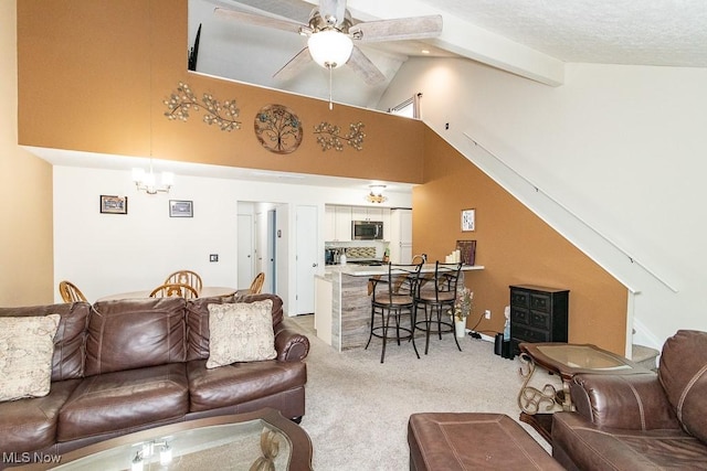 living area featuring light colored carpet, a textured ceiling, high vaulted ceiling, beam ceiling, and ceiling fan with notable chandelier