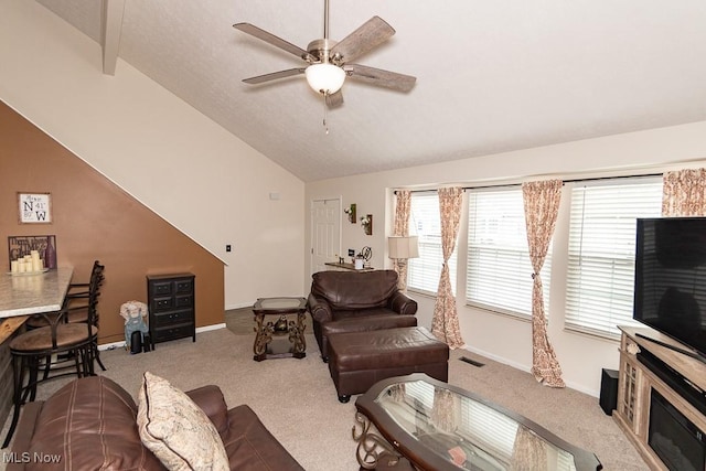 living area featuring carpet, ceiling fan, lofted ceiling, and baseboards