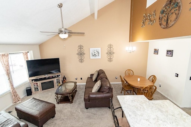 carpeted living area featuring lofted ceiling, ceiling fan with notable chandelier, and baseboards