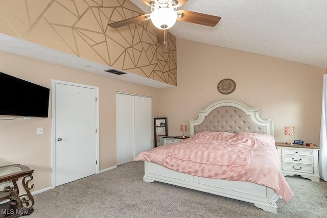 bedroom with carpet floors, lofted ceiling, a closet, and visible vents