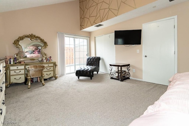 living area with high vaulted ceiling, carpet flooring, and visible vents