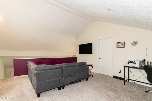 living area with lofted ceiling with beams, a textured ceiling, and carpet flooring