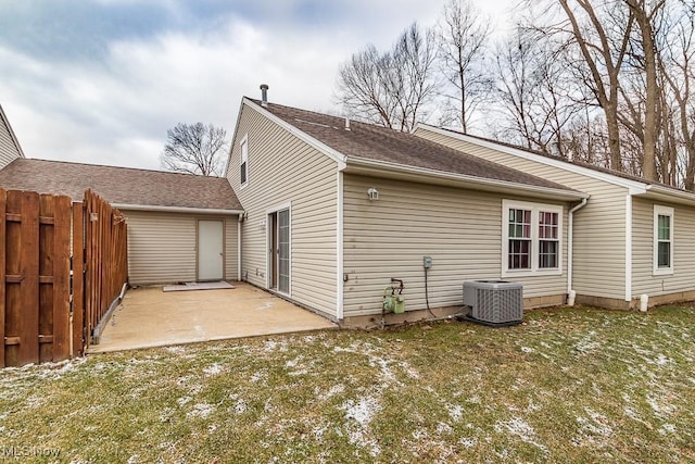 rear view of house featuring central AC, a lawn, a patio area, and fence