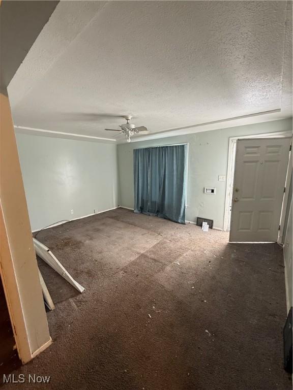 interior space featuring a textured ceiling and a ceiling fan