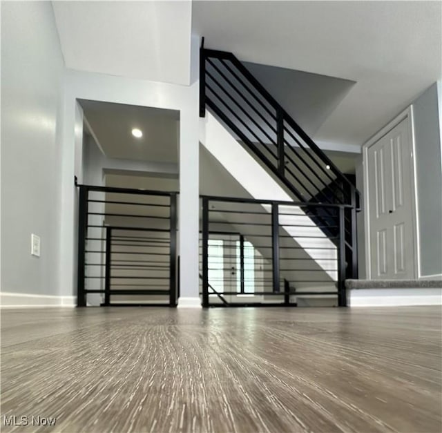 interior space with baseboards and wood finished floors