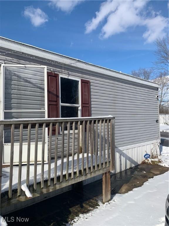 view of snow covered rear of property