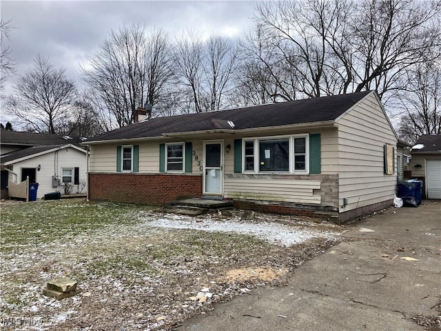 view of front of home featuring brick siding and a chimney