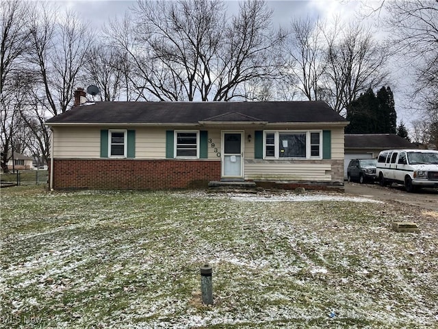 view of front of home featuring brick siding, fence, and a chimney